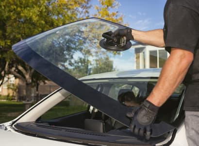 Technician installing a windshield on a car